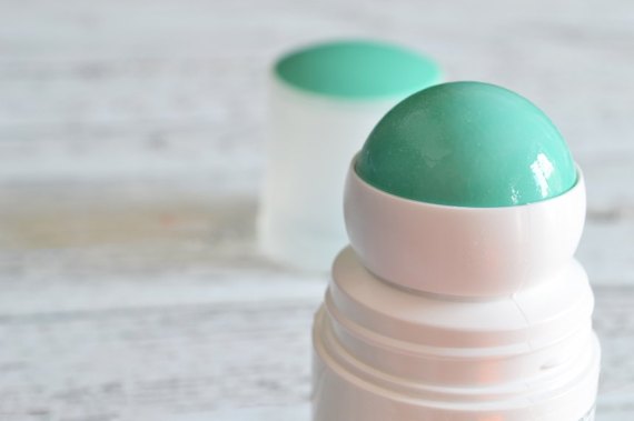 roll-on deodorant with a lid in the background